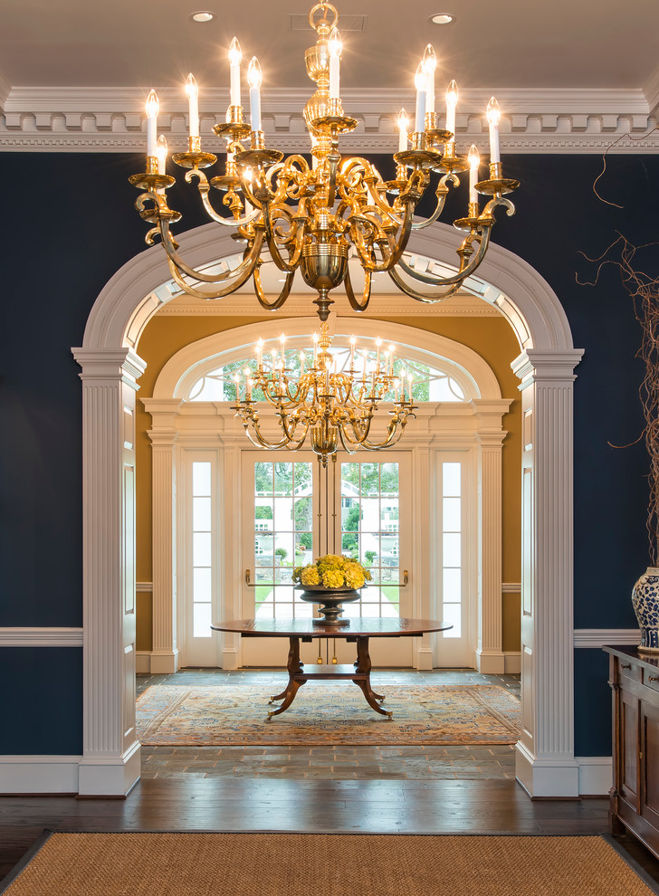 navy blue walls front entrance chandelier decor