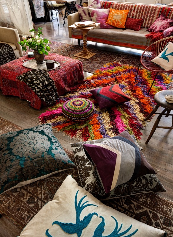 bohemian living room decorating full of rugs layering