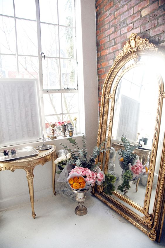 large-gold-mirror-leaning-on-wall-decorating-ideas